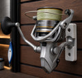 Fishing reel with spool of line on a wooden background