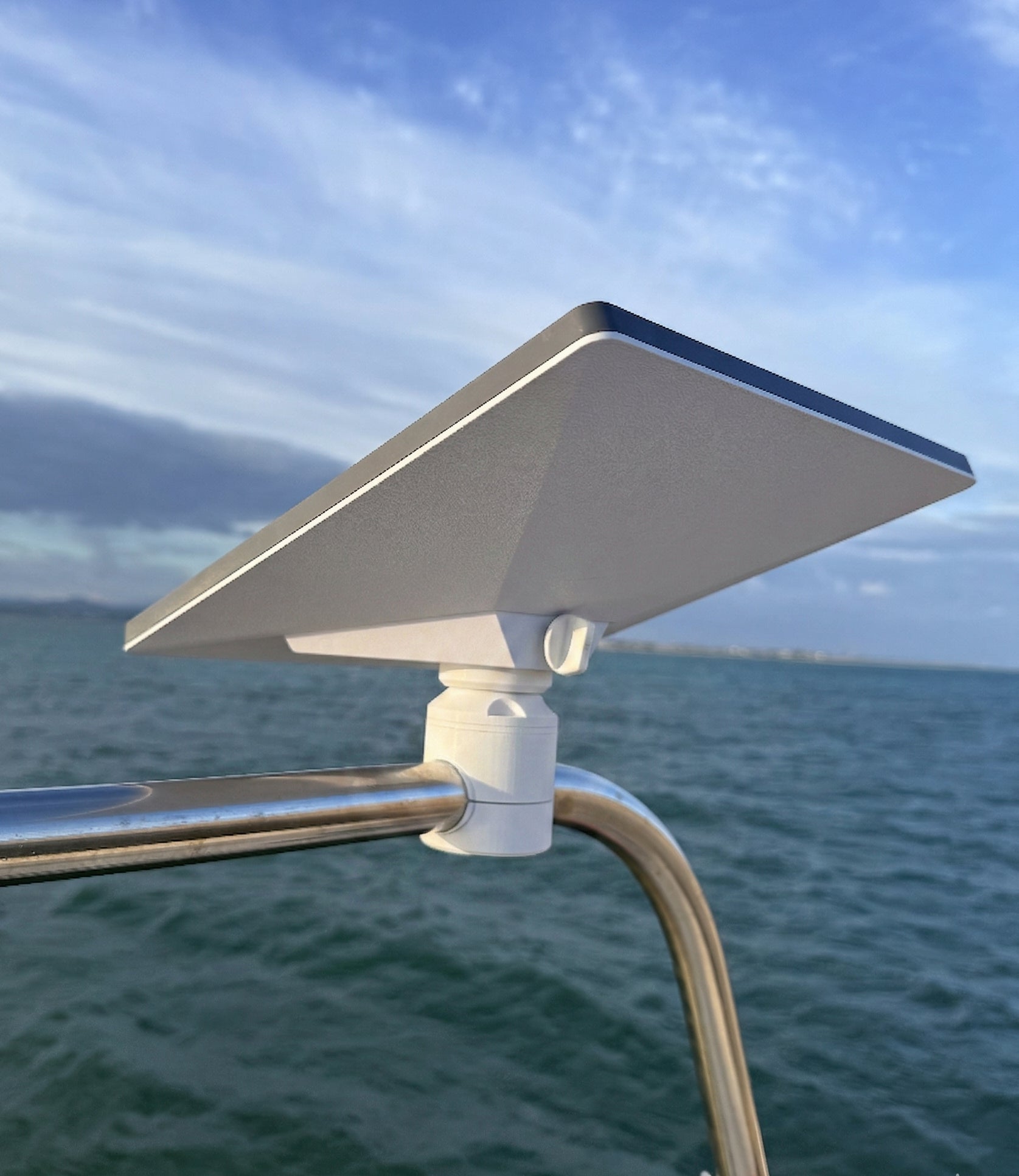 Starlink mini mounted on a boat railing with ocean and sky in the background